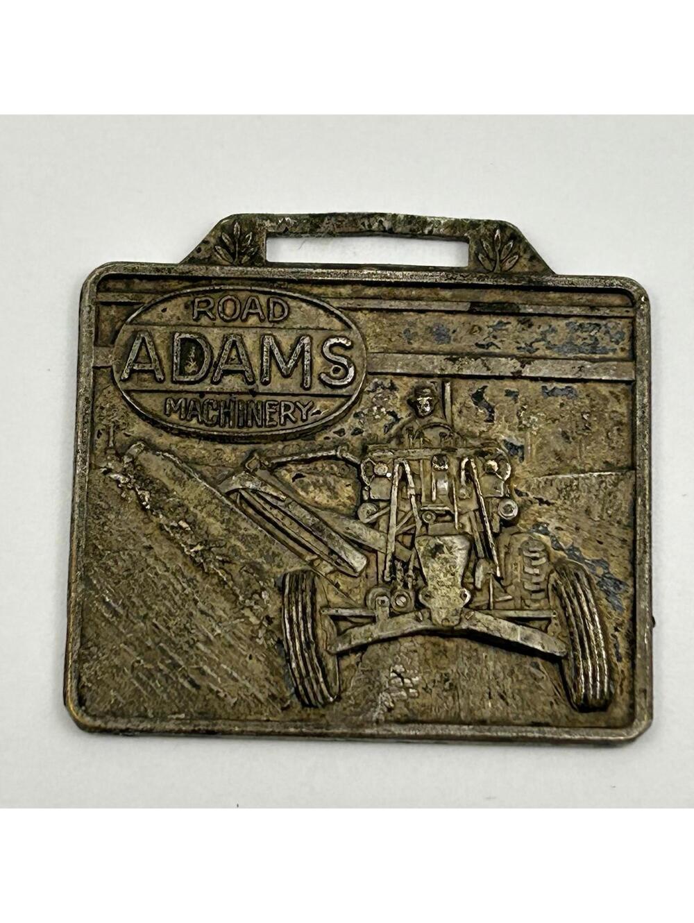 Vintage Adams Road Machinery Watch Fob Grader Construction Advertising Tag